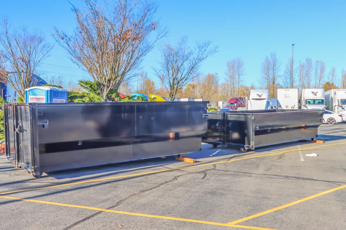 Professional dumpster rental service with roll-off container on residential driveway in New Ipswich